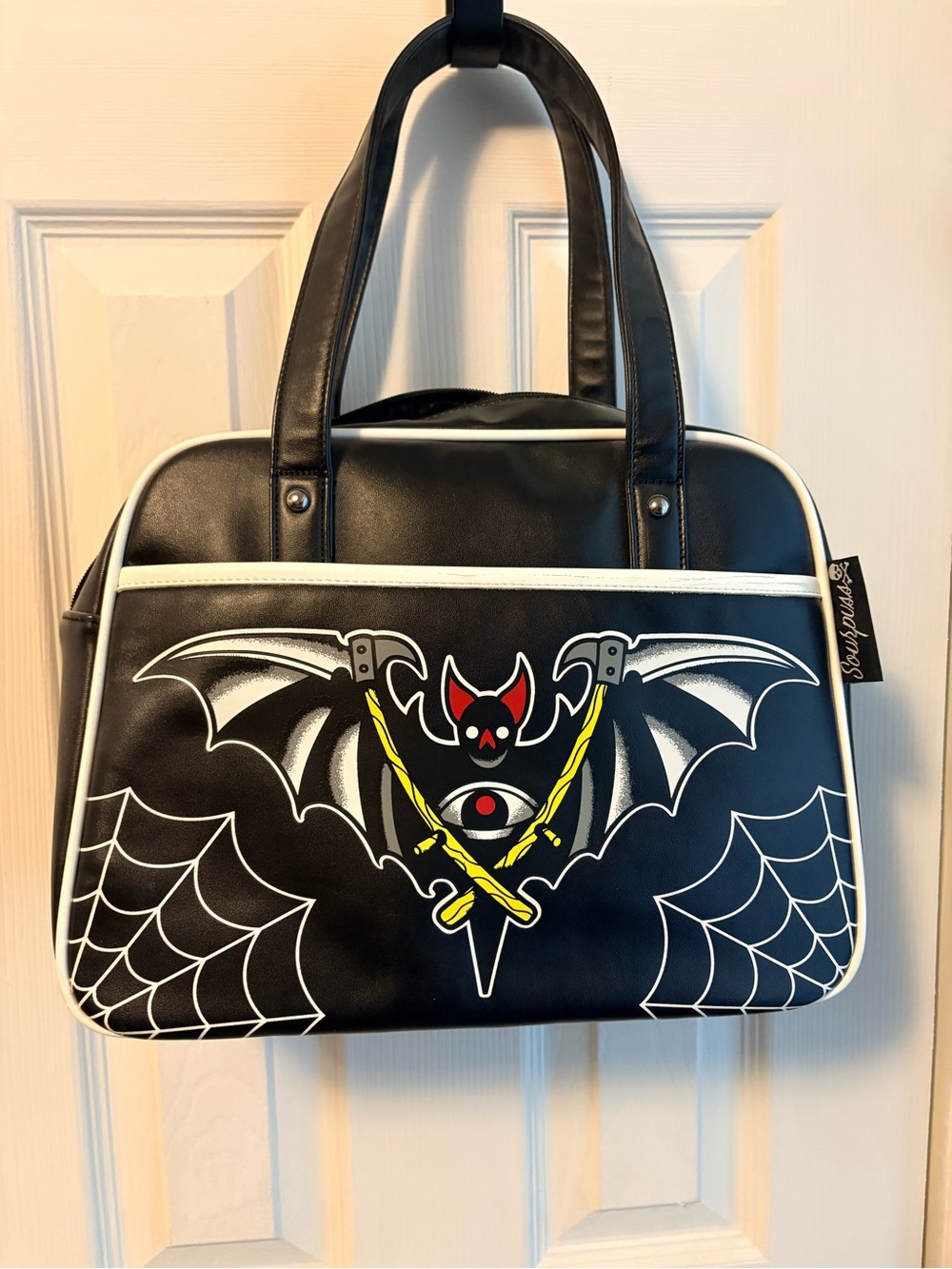 Sourpuss Black Shoulder Bag with White Trim and Yellow Accent Bat Graphic